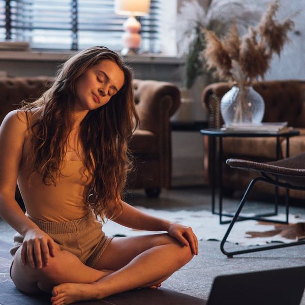 Person practicing a gentle stretching yoga pose in a tranquil environment.